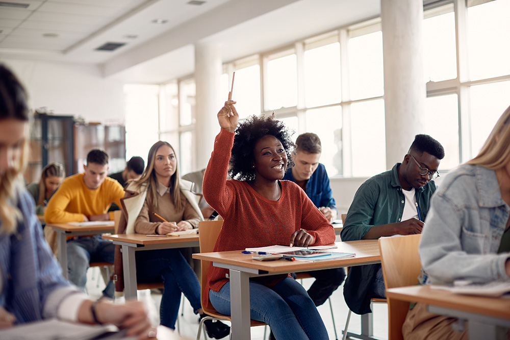 Person raising hand in classroom
